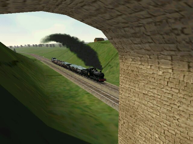 a train coming out of the tunnel with a black smoke plume coming out