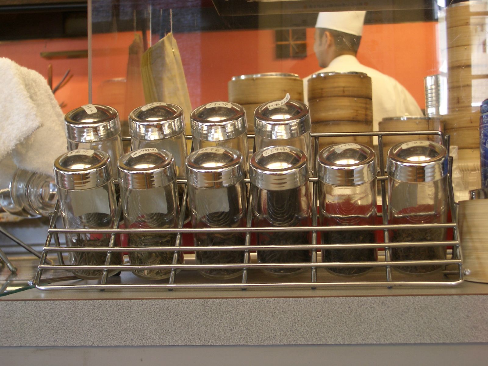 a display case with spice bottles on the counter