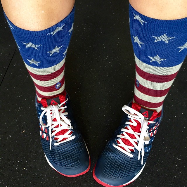 a person wearing blue sneakers and an american flag sock
