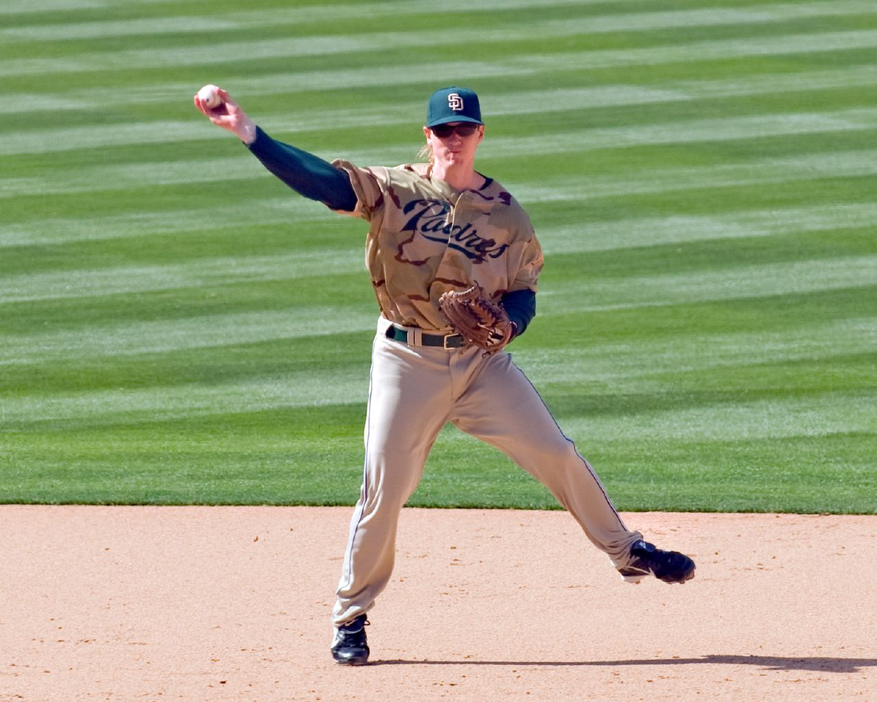 a man in uniform on a baseball field throwing a ball