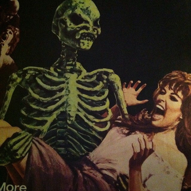 an image of a woman with fake skeleton behind her