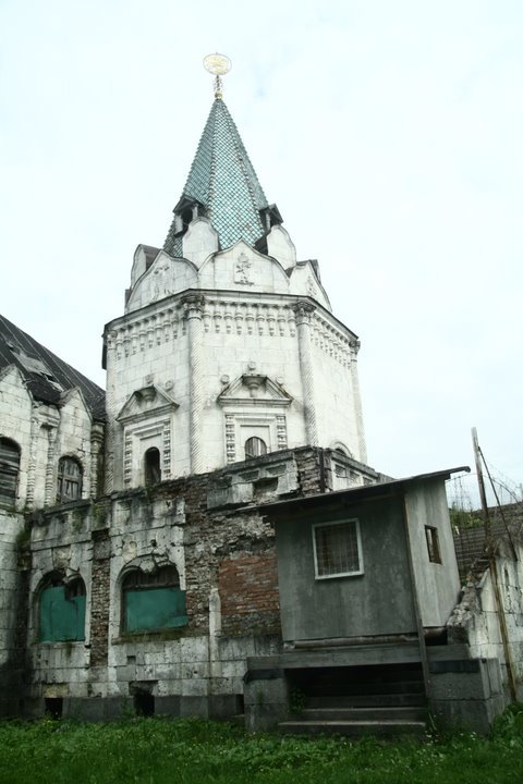 this is an old building with a steeple and windows