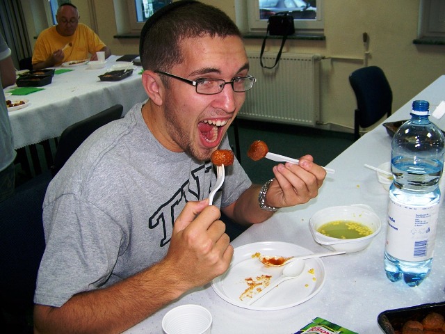 a man eating food at a restaurant table