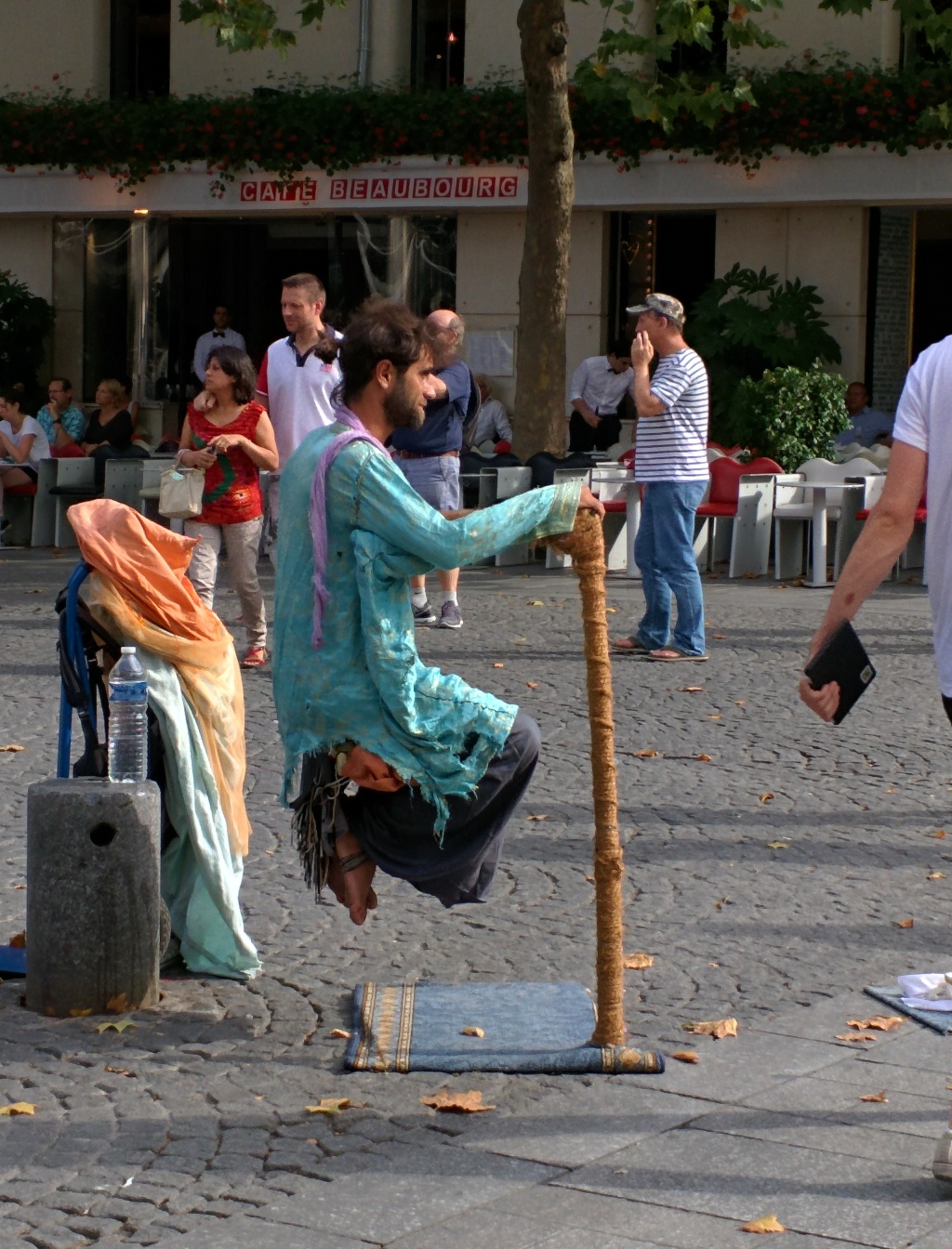 a person in a green outfit on a pole