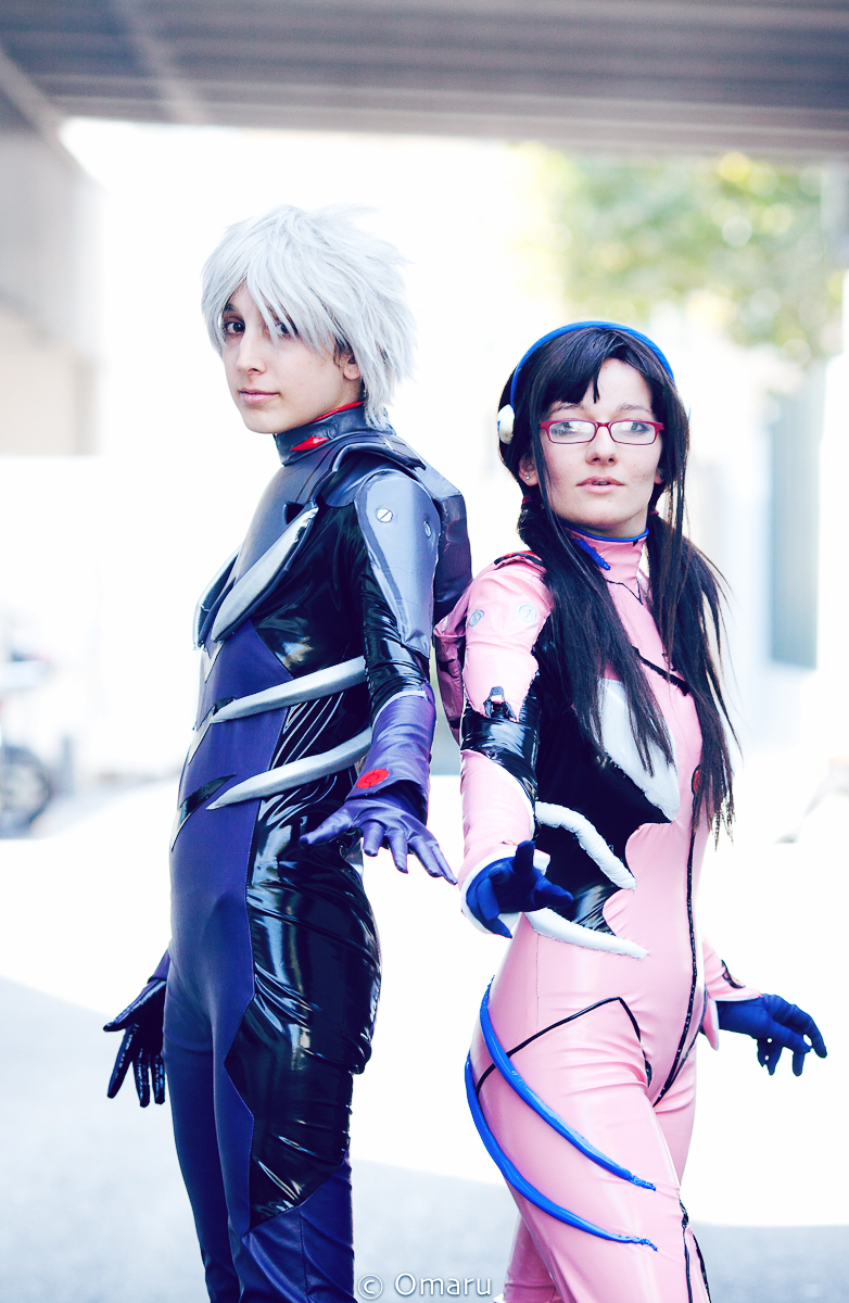 two female cosplays in costume walking down a street