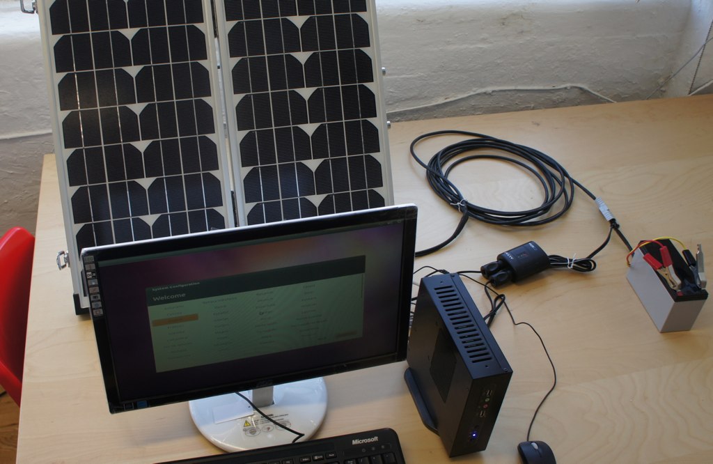 a desk with two solar panels on top and one electronic device on the table