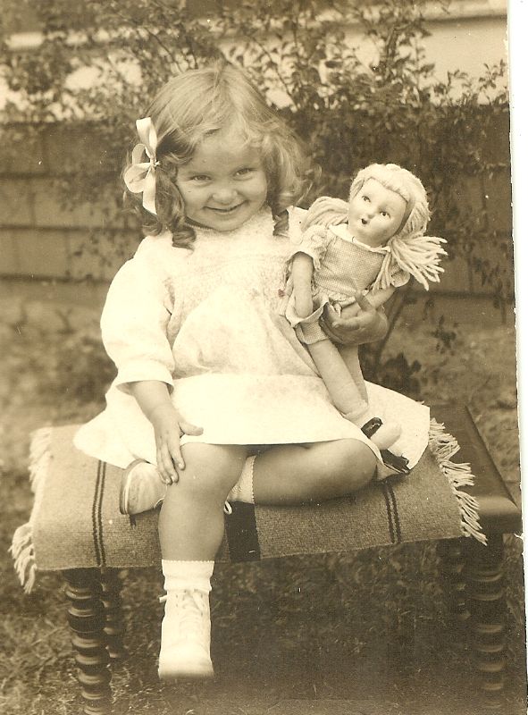 this is an old po of a small girl with two dolls