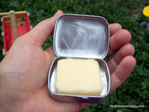 a man is holding out a container with some cream in it