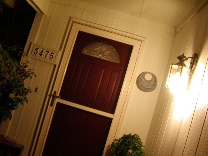 a doorway and entryway light next to the door
