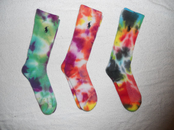 three pairs of tie dyed socks are next to each other