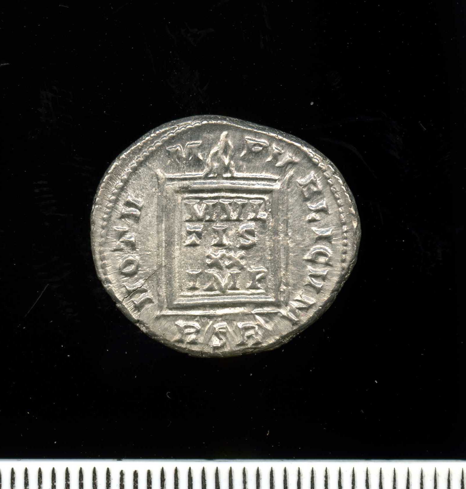 an antique coin, featuring the letter d