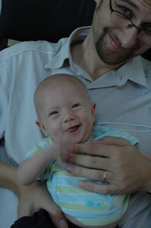 a man holding a baby in his arms