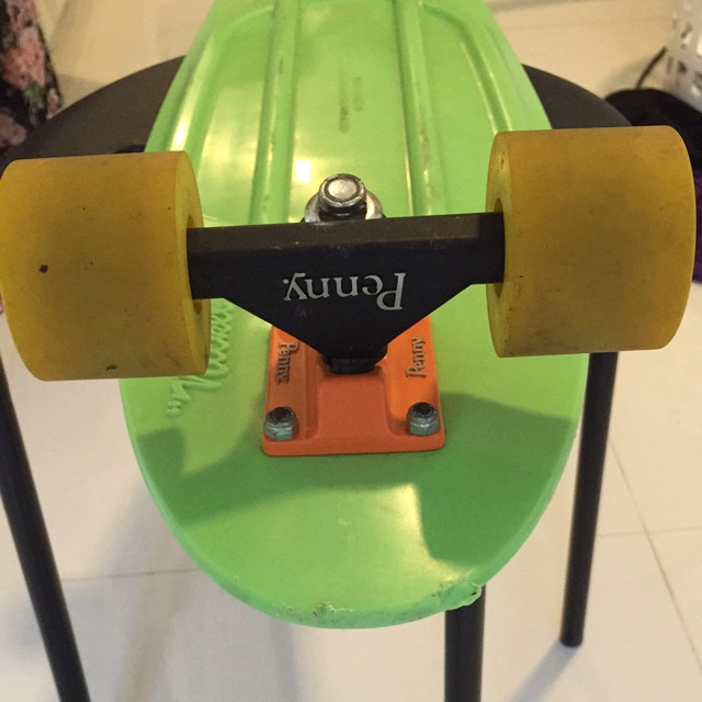 an orange and yellow skateboard on a green board