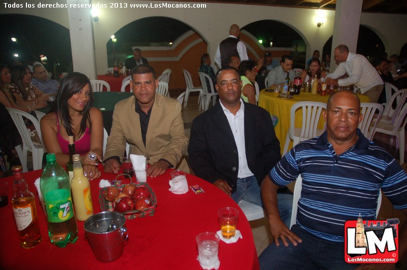 several people are sitting at a table at a party