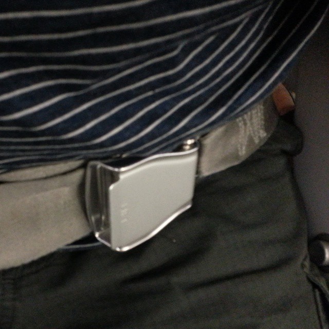 a belted waist with a cell phone in it