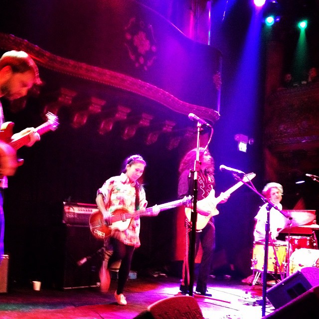 the musicians perform on the stage with a purple lighting