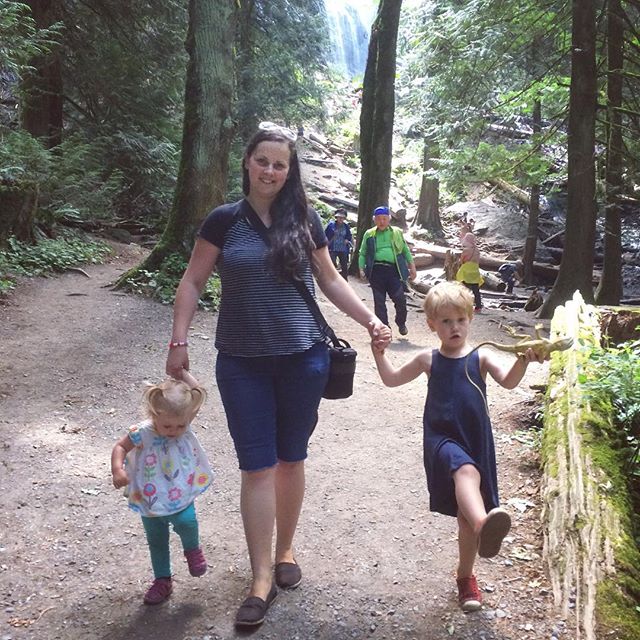 the mother and child are walking in the forest