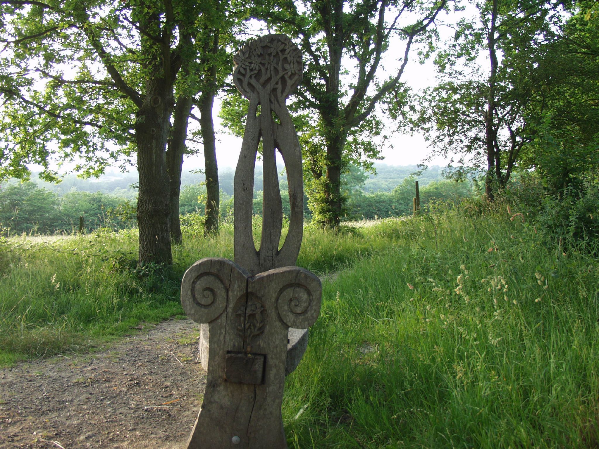 statue of an ornate head in grassy area