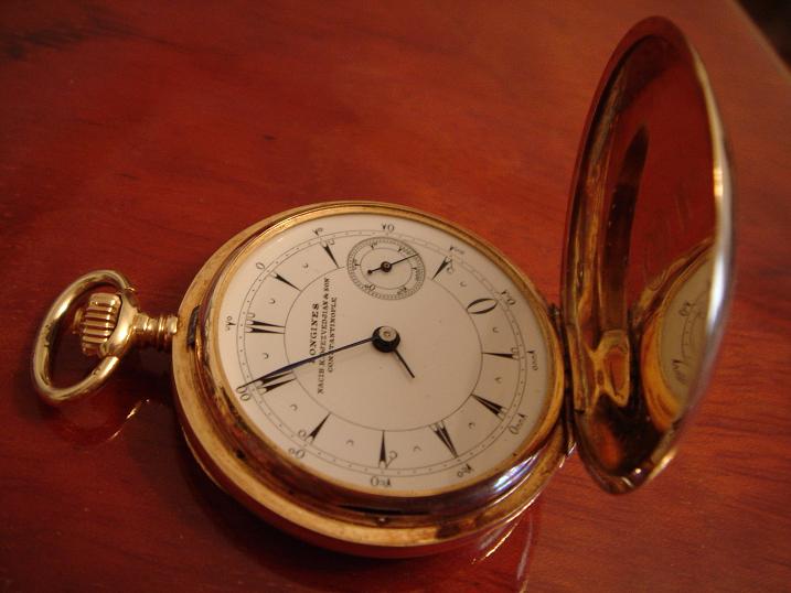 a pocket watch sitting on a wooden table