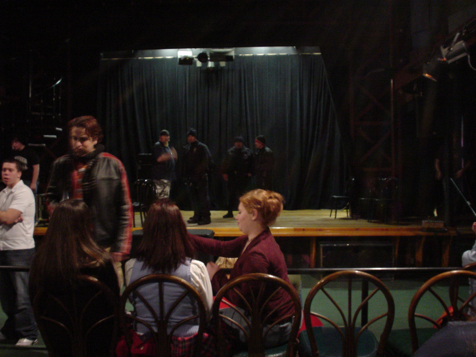 a group of people standing around in front of a stage