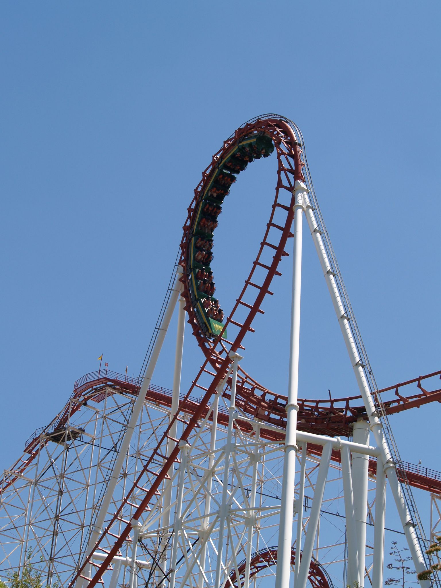 an outdoor area of the theme park with a roller coaster