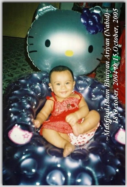 a baby sitting on an inflatable hello kitty pool