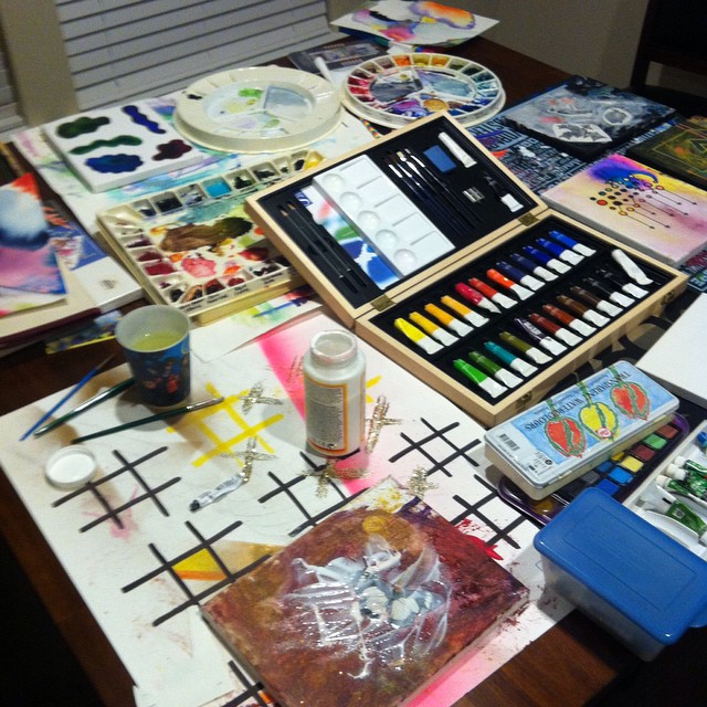 painting supplies on the table with a tray full of paint