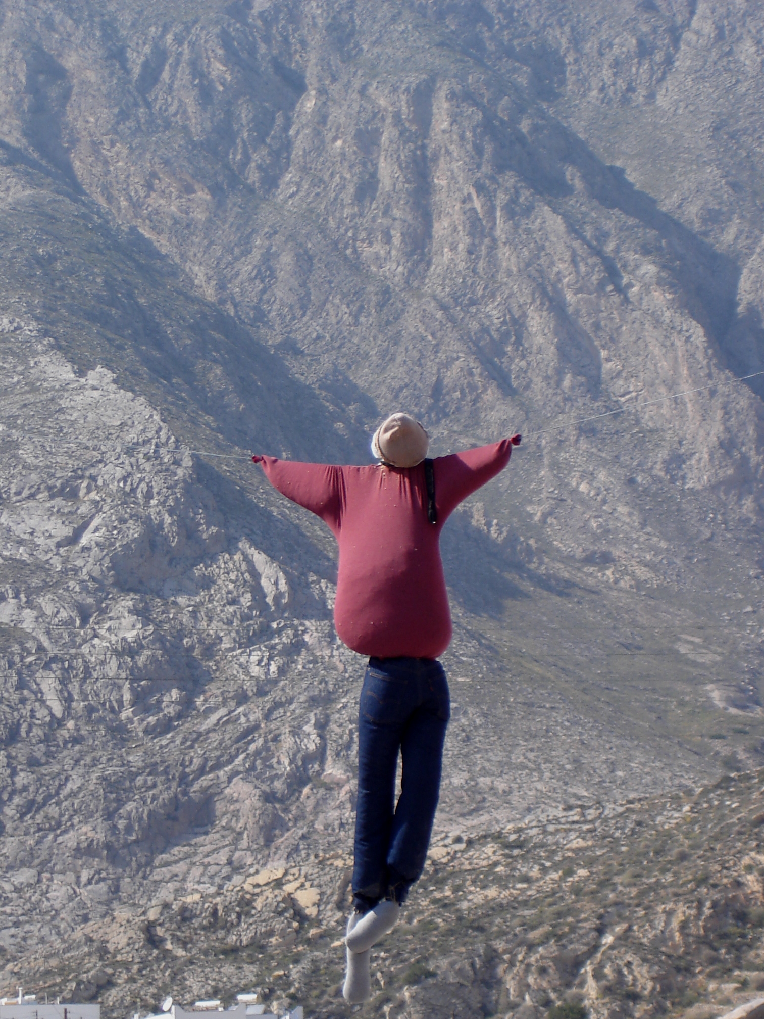 a person in a red sweater and white hat flying through the air