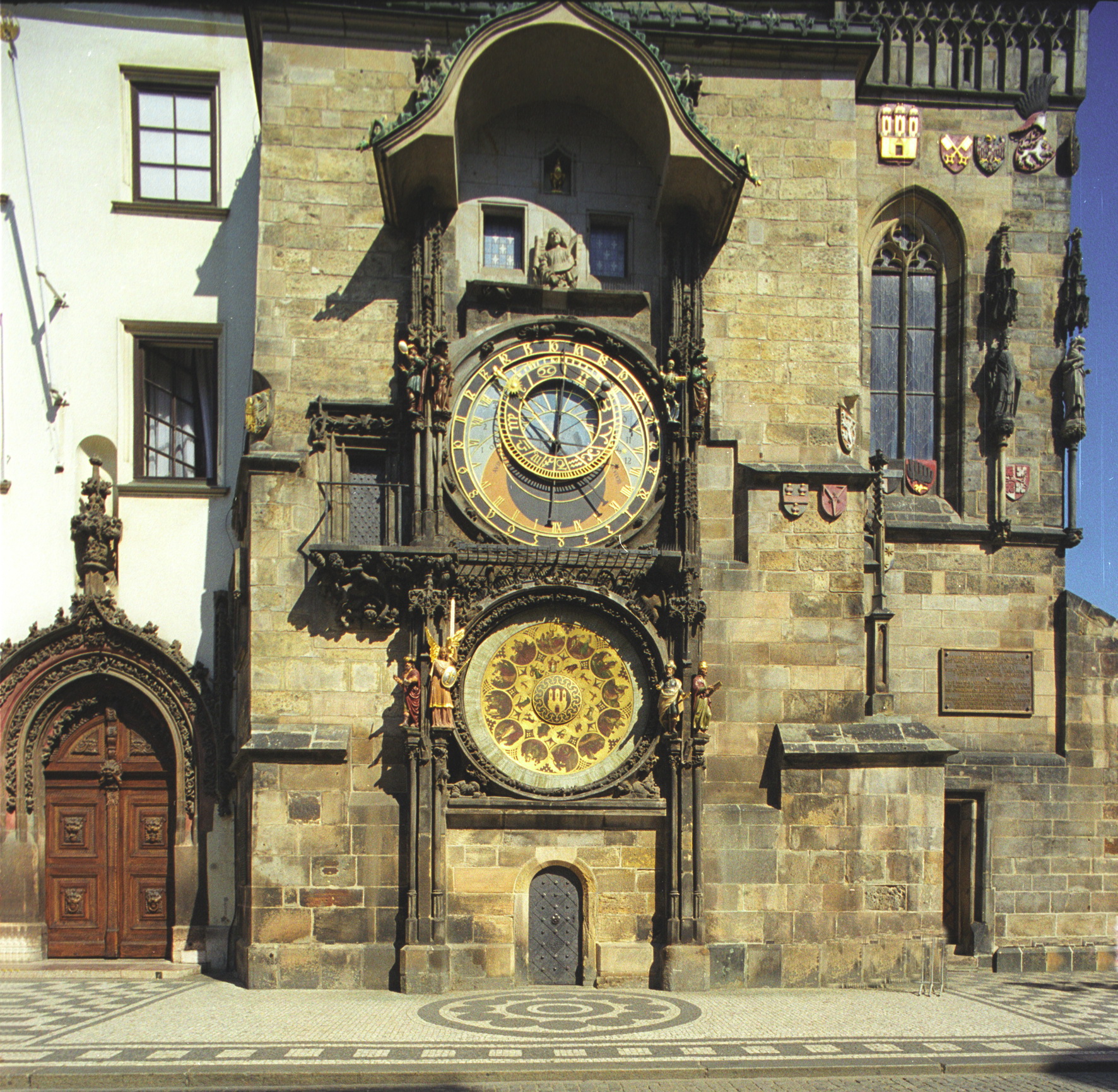 a tall stone building with two large clocks on the front
