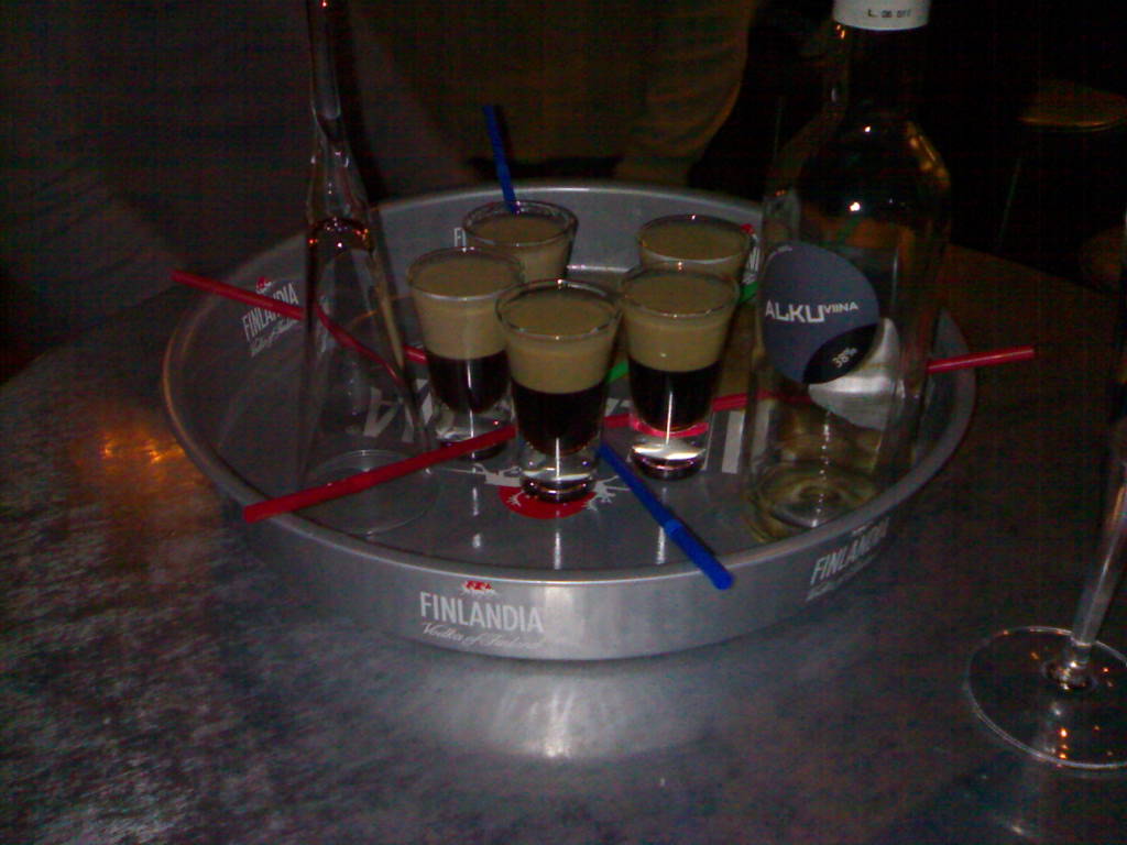 a set of five glasses and a tray on a table