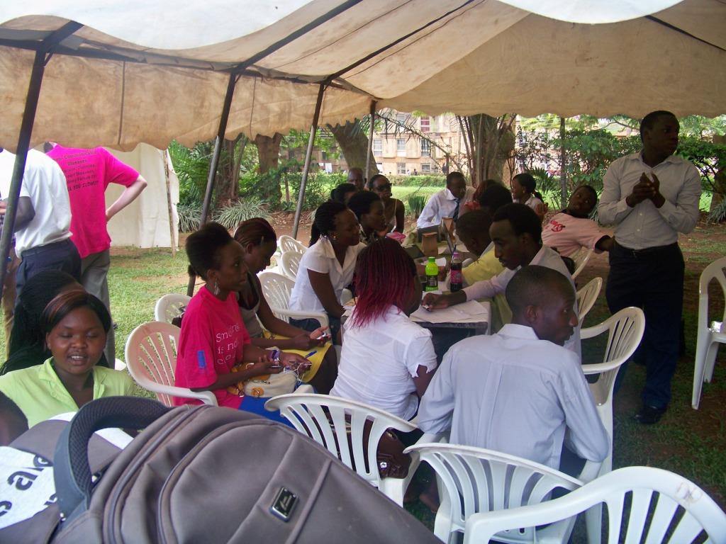 a group of young people sitting under a tent