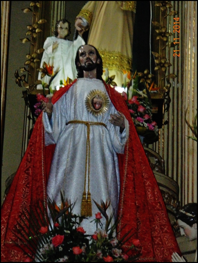 statue of christ in church with figures in the background