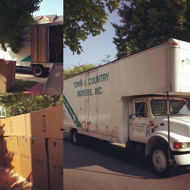 a delivery truck hauling supplies parked in a driveway