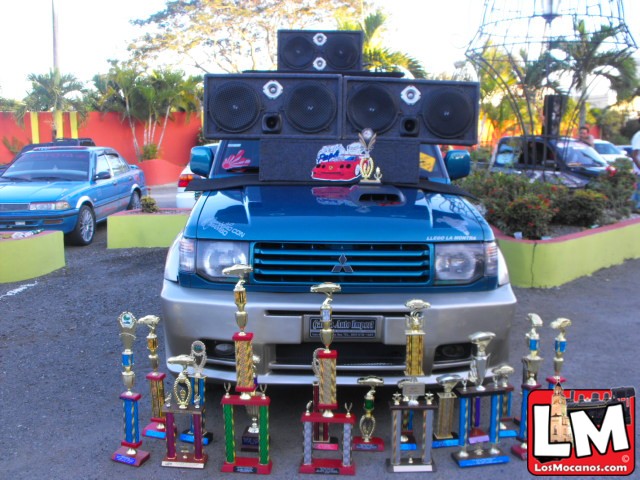 the blue car is loaded with trophies and sound devices