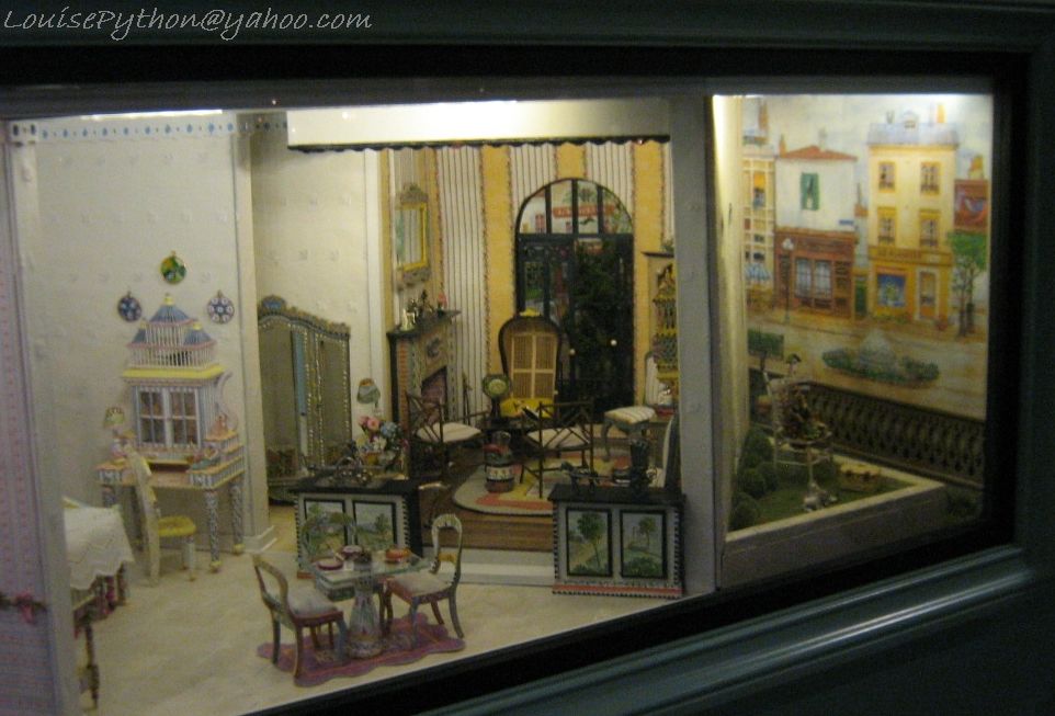 a dollhouse inside of a house in the window