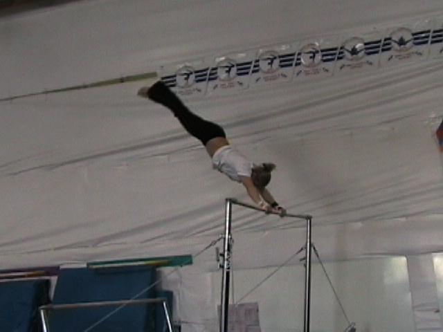a man on a pole performing tricks inside