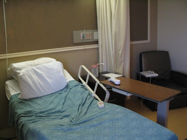 an empty hospital bed in a small room