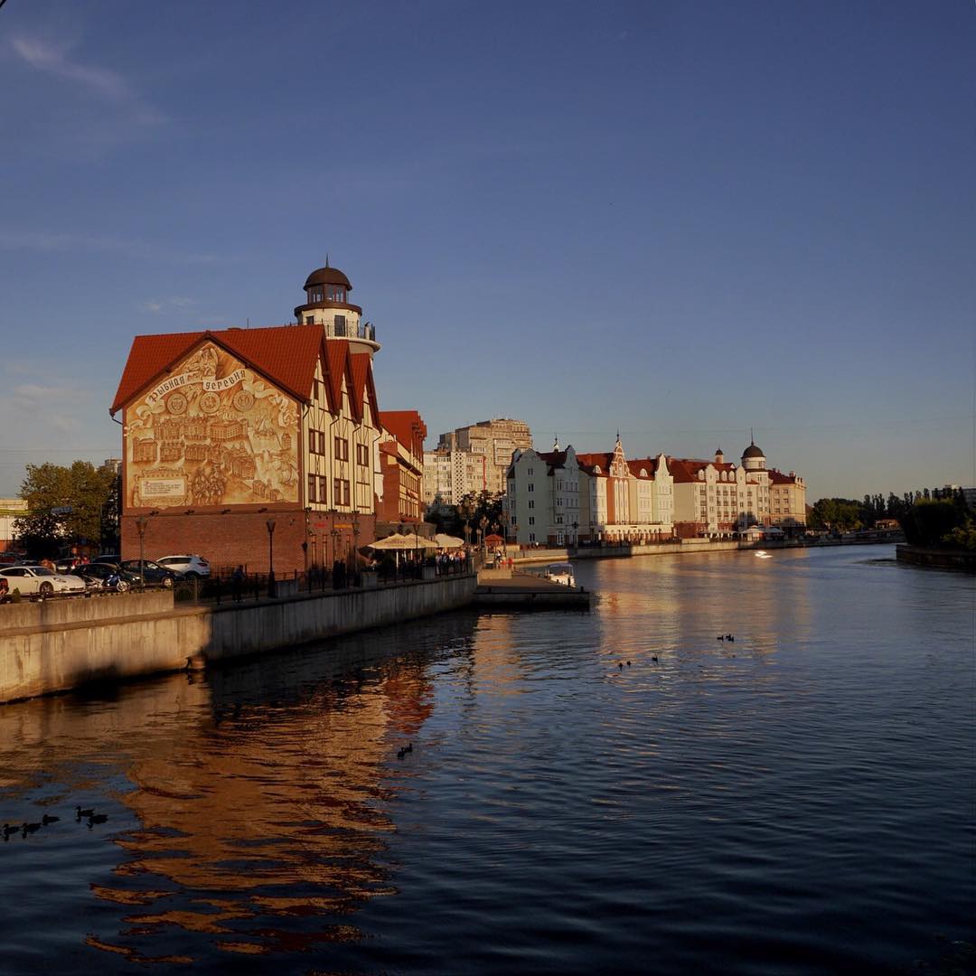 a body of water surrounded by a large building with a tower