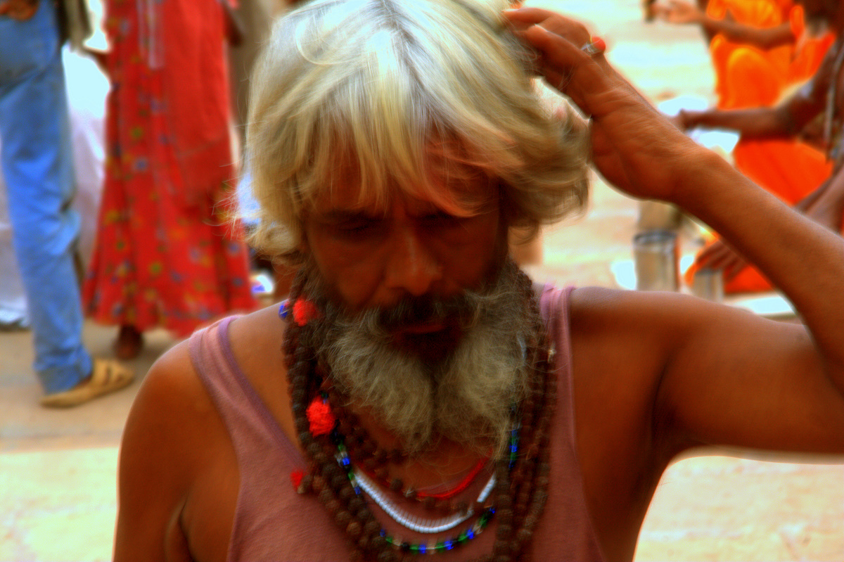 a man with a white beard and a red necklace