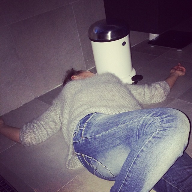 a woman sitting on the floor next to a water dispenser