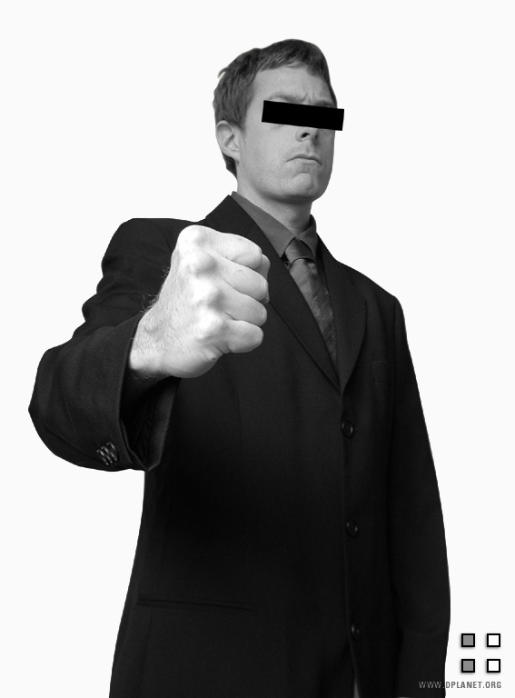 a man in a business suit and blindfolded by the man's face