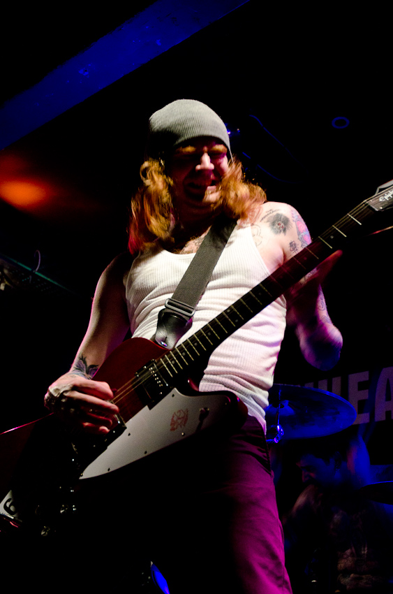 a man is playing guitar at a concert