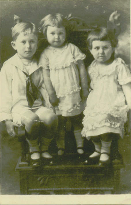 two children with one baby sitting on top of the other