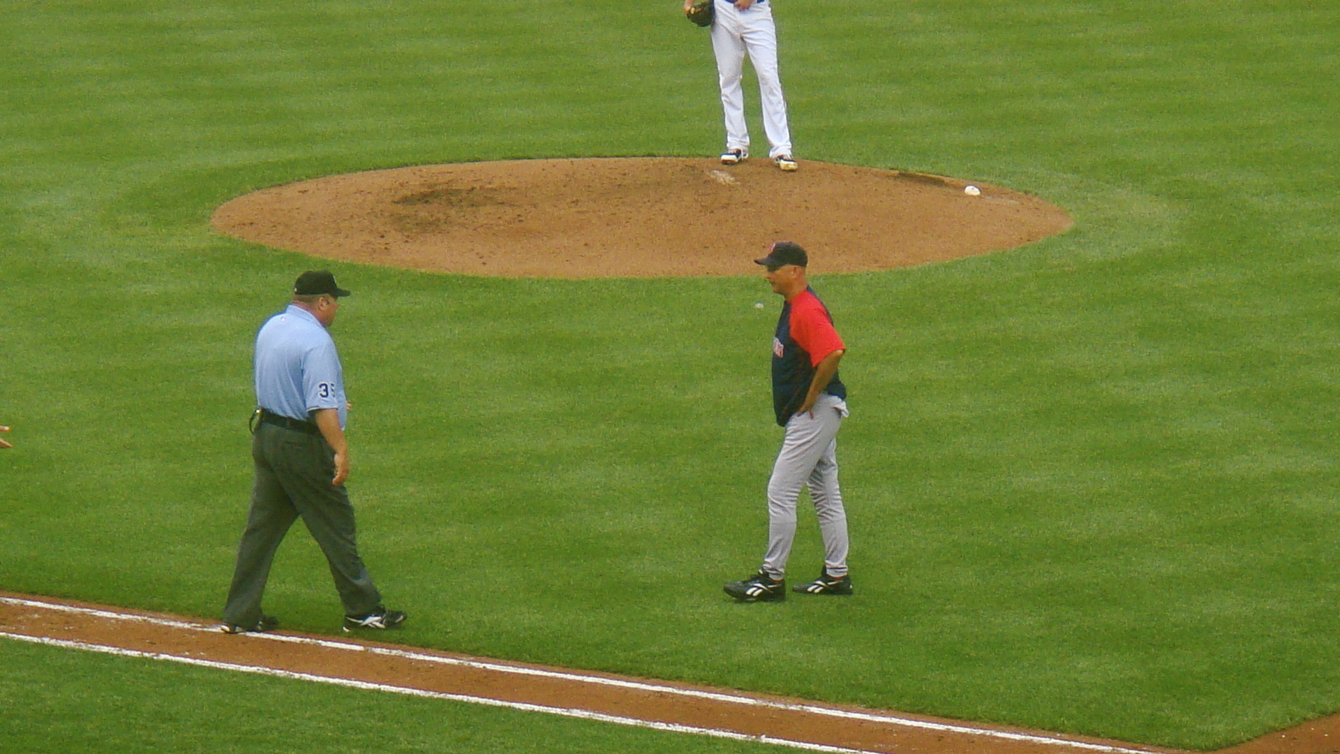 two men are on the field with baseball equipment