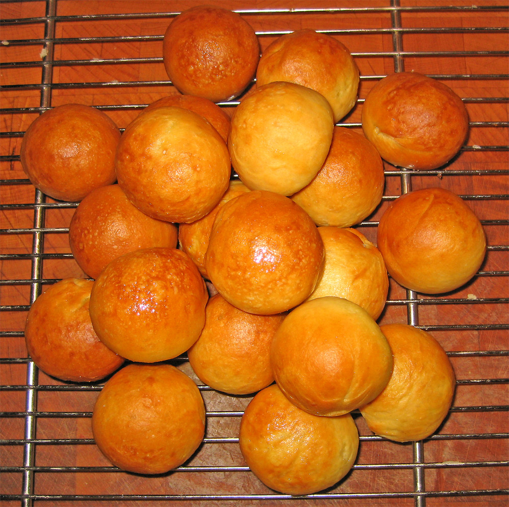a pile of bread rolls on top of a wire rack
