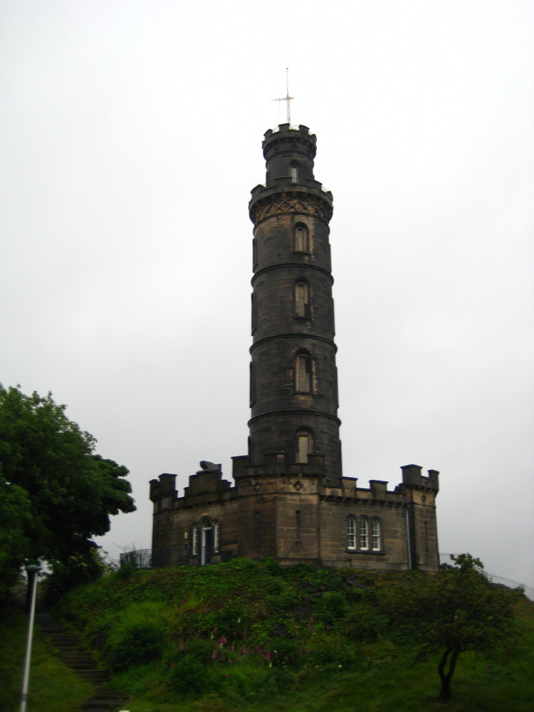 an old fashioned stone tower on a hillside
