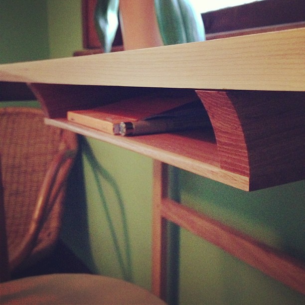 closeup of a shelf with books and magazines under it