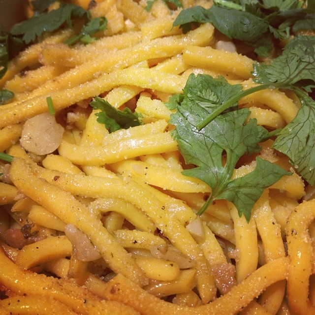 a close up view of pasta with cheese and herbs