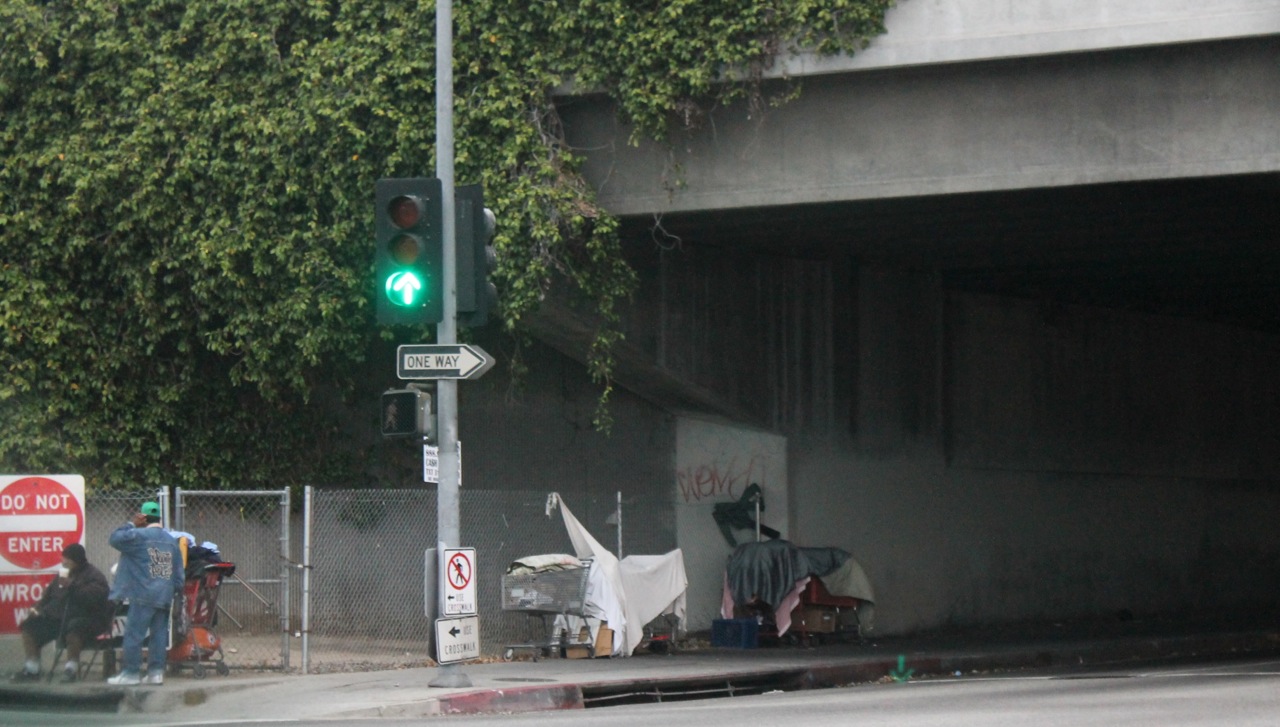 a pedestrian is crossing at an empty, crowded intersection