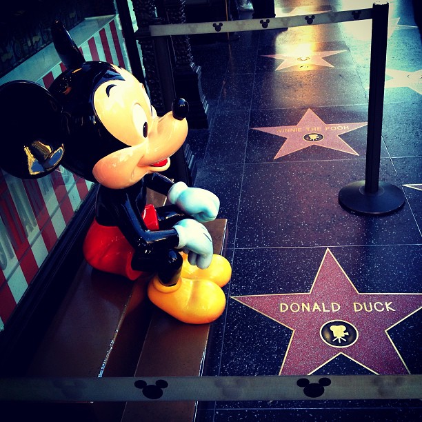 a mickey mouse statue sitting on a star